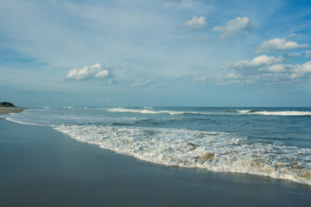 Beautiful seascape with waves tides on the sandy beach and blue sky. Nature Landscape scenery beautyの写真素材