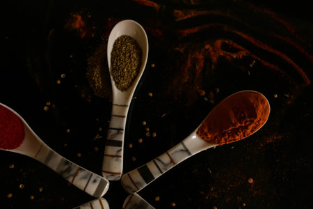 Spoons with spices on a black background. Spices on a black background. Food backdrop background wallpaperの写真素材
