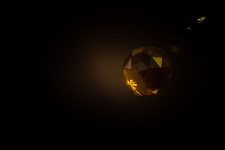 Golden Crystal Christmas ball Shining on a black background with copy space for text.の写真素材