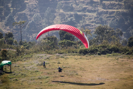 Paraglider flying in the sky over the mountains experiencing extreme adventure sport. Holidays funの写真素材