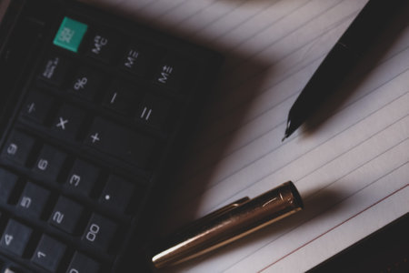 calculator, pen and notebook on wooden table, business conceptの写真素材