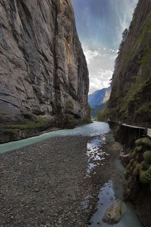 Shallow part of mountain river between sheer rocksの写真素材