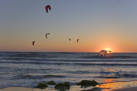  Flight of parachutes above the sea on a sunsetの写真素材