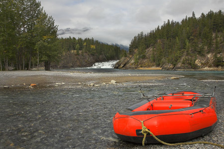  Red boats of a kayak on coast of the mountain river in Canadaの写真素材