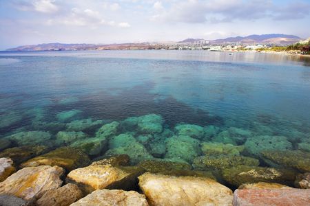  A shallow gulf with the transparent greenish water, surrounded by anchor buoys, in the big southern sea resortの写真素材