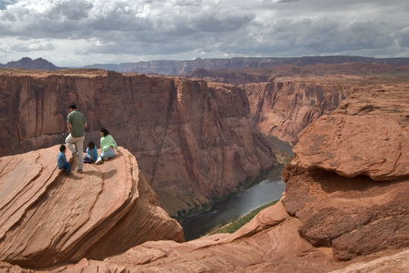  Group of tourists on edge of a deep canyon Horseshoe in state of Utah in the USA