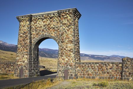 Huge stone gate on an input Yellowstone national park and when there ascends the sunの写真素材