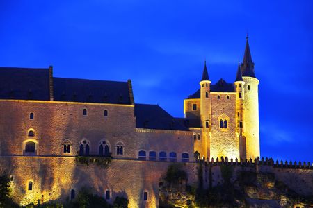 Palace of Spanish kings Alkasar in Segovia in twilight on a background of the cloudy skyの写真素材