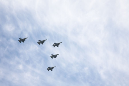 The squadron of warplanes flying in the cloudy sky