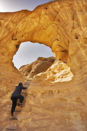 The woman - tourist rises to picturesque arches in ancient mountainsの写真素材