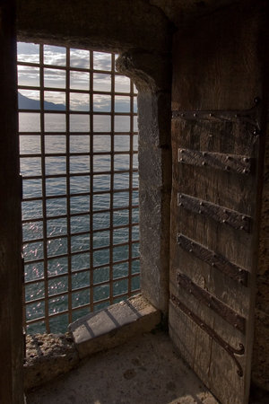  The big window aperture closed by a lattice in a fortress ?hillon on coast of lake Lemanの写真素材