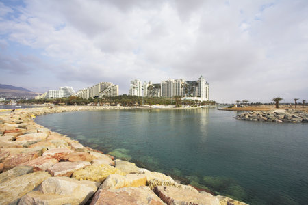 A shallow gulf with the transparent greenish water, surrounded by anchor buoys, in the big southern...