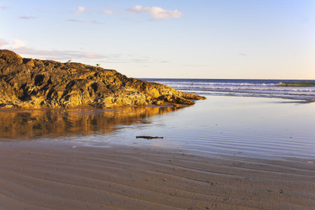 Small picturesque islands on an colossal sandy beach of Pacific coast of Canadaの写真素材