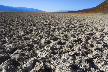  A dry waterless clay surface and mountains in the distanceの写真素材