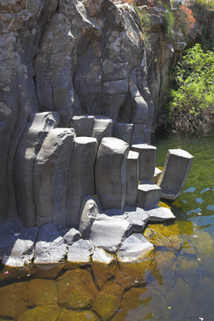 Canyon with cut basalt walls and a drying up stream