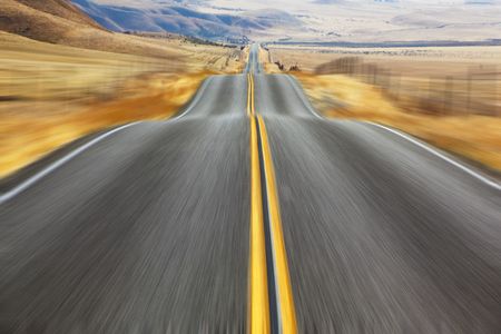  A Mirage on high speed. Magnificent American road and fencings on roadsides from snow driftsの写真素材