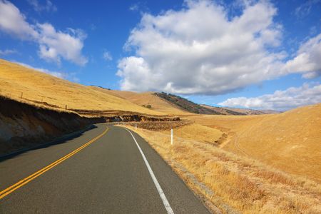 American roads. The magnificent American road passes between autumn hills of Californiaの写真素材