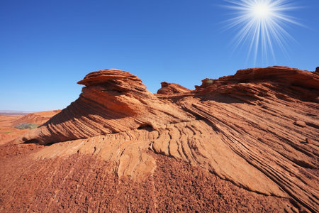Walking around the famous Horseshoe Canyon in the U.S.. Shining sun in the blue skyの写真素材