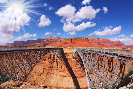 The famous double Navajo Bridge over the River Colorado separately for transport and for pedestrians. The sun is shining on a lovely autumn dayの写真素材
