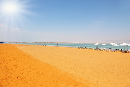 Middle-aged woman on the beach luxury hotel on the Dead Sea in Israel. Sunny spring dayの写真素材