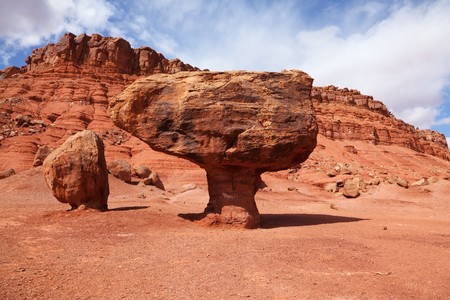 Grandiose panorama - stone desert from red sandstone and the well-known rock in the form of a mushroom. Windy solar autumn dayの写真素材