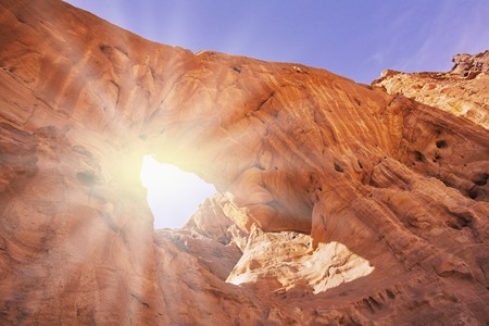 Natural erosive arch in hills from red sandstone in desertの写真素材