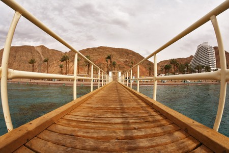 Wooden pier on a beach of Red sea in Eilatの写真素材