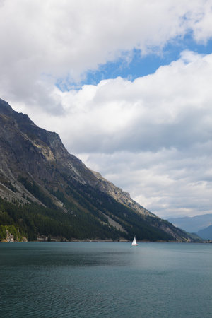 The magnificent sailing yacht on mountain lake. The Swiss Alpes, early autumnの写真素材