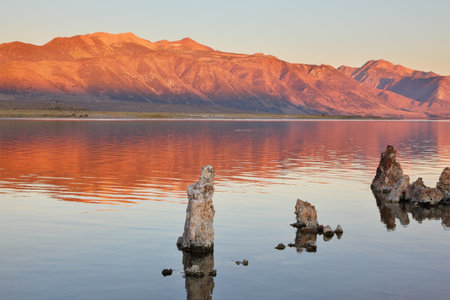 Extremely beautiful landscape. Mono Lake on a sunset. Lake stalagmites of the Tufa are reflected in smooth water of lakeの写真素材
