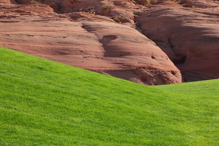 Hills from red sandstone and green grassy hills for a golfの写真素材