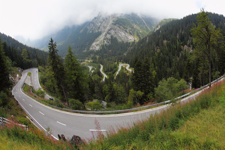 A winding mountain road - Serpentine, lighted autumn sun  Photo taken by lens Fisheye