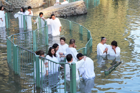 Yardenit, Israel - January 21: Christian pilgrims ritual baptism in the waters of the Jordan River in the days of the Feast of Holy Baptism 21 January 2012 at Pilgrim baptismal site Yardenit, Israel. Pilgrims enter the water, dressed in special white chriのeditorial素材