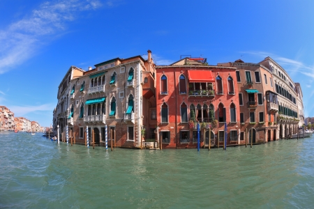 Magnificent Venetian palace on a sunny day, surrounded by the waters of the channel mirror. Photo making the lens Fisheyeの写真素材