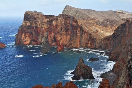 Red rocks and blue sea. Eastern end of Madeira Island at sunset. Deep Bay with picturesque islands - rocksの写真素材