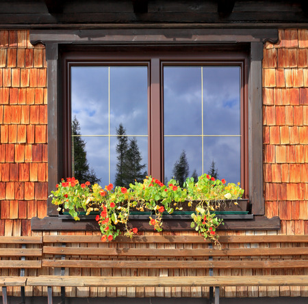Dachstein huge tourist complex in Austrian Alps. Picturesque popular cafe window with flower potsの写真素材