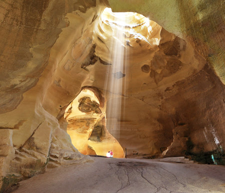 Bell caves of Beit Guvrin. Israel National Park.  Picturesque clay arches illuminated by the sun from the hole at the top and side entrancesの写真素材