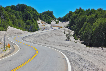 Winding road in Chilean Patagonia, covered volcanic ashの写真素材