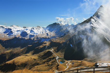 Austrian Alps. Excursion to the picturesque panoramic way Grossgloknershtrasse. Sunny day in early autumn. Great highway winds between hillsides yellowed.  The picture was taken Fisheye lensの写真素材
