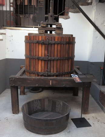 FUNCHAL, MADEIRA - OCTOBER 08, 2011: The museum - storage of expensive vintage wine Madeira. An ancient press for a grapes extractionのeditorial素材