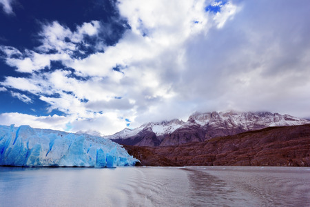 Chilean Patagonia. National Park Torres del Paine. Lake and Glacier Grey. The clouds covered the sun cold. Grey glacier moves down the water of the lakeの写真素材