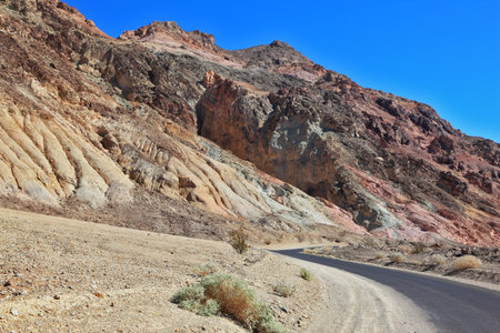 A great American road. The road to dry and wild-colored mountains of Death Valleyの写真素材