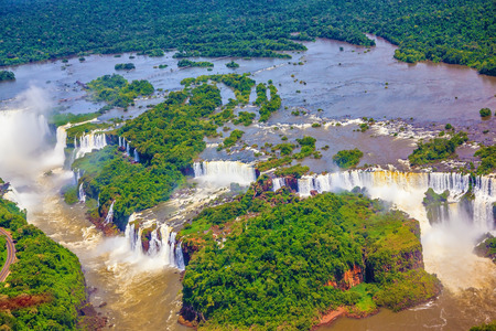 Waterfalls are located in the two national parks - Argentina and Brazil in the dense tropical forests. The famous Iguazu Falls on the Brazilian-Argentine border. Picture taken from a helicopterの写真素材