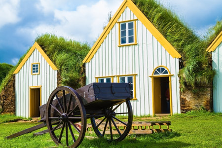 The ancient two-wheeled wooden cart on the front lawn. The village first settlers in Iceland. The reconstituted village - Pioneer Museum - Vikingのeditorial素材