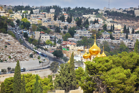 Golden domes of an Orthodox church of Mary Magdalene. Ancient holy Jerusalem from the Mount of Olivesの写真素材