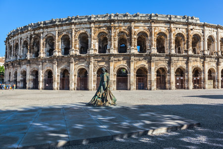 Roman amphitheater in Nimes, Provence. Monument to bullfighter installed in the squareのeditorial素材