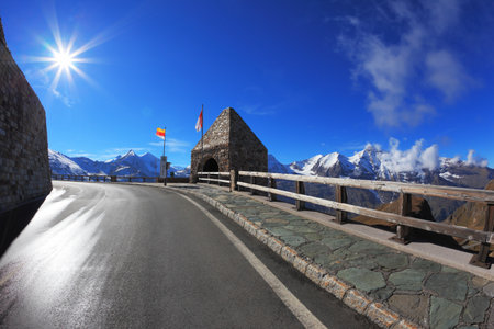 Bright sunny day. Picturesque alpine road Grossglocknershtrasse. Photo taken by lens Fisheyeのeditorial素材
