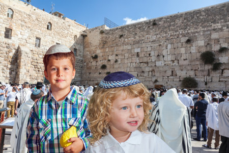 Cute little boy in a skullcap and his older brother seven years. They cost at Western Wall of Temple. The Jewish holiday of Sukkotのeditorial素材