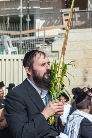 JERUSALEM, ISRAEL - OCTOBER 12, 2014:  Morning autumn Sukkot. The area in front of Western Wall of Temple filled with people. Pilgrims brought the prayer ritual and four plantsのeditorial素材