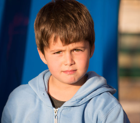 Very beautiful six year old boy with green eyes playing in the playground. Beautiful sunny winter...