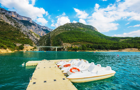 Wooden pier with white catamaran. Large bridge over river Verdon.  National park Merkantur, Provence, Franceの写真素材